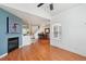 Open-concept living area showcasing fireplace, hardwood floors, and dining area nearby at 2408 Concord Cir, Lafayette, CO 80026