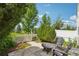 Backyard patio with a small table and chairs, white fence, and lush landscaping at 2408 Concord Cir, Lafayette, CO 80026