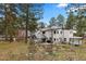 Spacious backyard featuring a covered patio, pergola, and lush landscaping, perfect for outdoor entertaining at 689 Red Deer Rd, Franktown, CO 80116