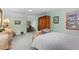 Inviting bedroom with green walls and a plush bed, complemented by a classic vanity at 689 Red Deer Rd, Franktown, CO 80116