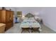 Comfortable bedroom with unique decor, including patterned rug, wood armoire and a large window at 689 Red Deer Rd, Franktown, CO 80116