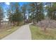 Long driveway leading to a home surrounded by mature trees providing lots of privacy at 689 Red Deer Rd, Franktown, CO 80116
