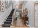 Elegant foyer featuring hardwood floors, a staircase, and tasteful decor at 689 Red Deer Rd, Franktown, CO 80116