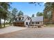 Charming two-story home with a three-car garage and a manicured front yard, nestled among mature trees at 689 Red Deer Rd, Franktown, CO 80116