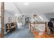 Open upper hallway with hardwood and carpet flooring, showcasing built-in bookshelves and natural light at 689 Red Deer Rd, Franktown, CO 80116