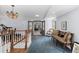 Upstairs hallway with chandelier, bench seating, and views into multiple living spaces at 689 Red Deer Rd, Franktown, CO 80116
