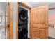 Convenient laundry area featuring a stacked washer and dryer unit neatly tucked away at 689 Red Deer Rd, Franktown, CO 80116