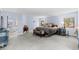 Large main bedroom suite with adjacent bathroom featuring paneled walls, king size bed, and sitting bench at 689 Red Deer Rd, Franktown, CO 80116
