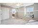 Bedroom with window seat, en-suite bathroom, and double doors at 10247 Telluride Way, Commerce City, CO 80022