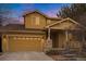 Two-story home with attached garage and landscaping at 10247 Telluride Way, Commerce City, CO 80022