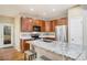 Open kitchen featuring an island with granite countertops, stainless steel appliances and wood cabinetry at 10247 Telluride Way, Commerce City, CO 80022