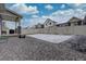 Spacious backyard with gravel area, white fence, and covered patio, perfect for outdoor living at 1048 Larkspur Dr, Erie, CO 80516