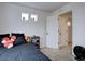 Cozy bedroom featuring neutral walls, carpeted floors, and three bright windows at 1048 Larkspur Dr, Erie, CO 80516