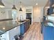 Modern kitchen with navy cabinets, stainless steel appliances, granite countertops, and a large island at 1048 Larkspur Dr, Erie, CO 80516