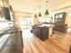 Bright kitchen boasting stainless steel appliances, a large island, and sliding glass doors to the backyard at 1048 Larkspur Dr, Erie, CO 80516