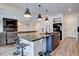 Beautiful kitchen featuring granite countertops, stainless steel appliances, and an island with bar seating at 1048 Larkspur Dr, Erie, CO 80516