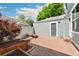 Private backyard with a brick patio, a garden bed, and detached garage at 7860 E Ellsworth Ave, Denver, CO 80230