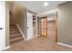 Finished basement entry with carpeted stairs and glass-paneled doors to basement rooms at 7860 E Ellsworth Ave, Denver, CO 80230