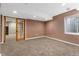 Basement room with new carpet, base trim, and new paint at 7860 E Ellsworth Ave, Denver, CO 80230
