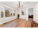 Dining room with large window and a view to the staircase and front room at 7860 E Ellsworth Ave, Denver, CO 80230