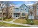 Beautiful two-story home with a covered front porch and brick detailing at 7860 E Ellsworth Ave, Denver, CO 80230