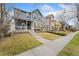 Charming two-story home featuring a covered front porch and well-manicured lawn at 7860 E Ellsworth Ave, Denver, CO 80230