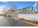 Charming two-story home featuring a detached garage and a well-maintained white fence for added privacy at 7860 E Ellsworth Ave, Denver, CO 80230
