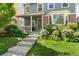 Inviting home exterior with a charming front porch, well-kept lawn, and beautiful landscaping at 7860 E Ellsworth Ave, Denver, CO 80230