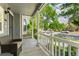 Inviting covered front porch offers relaxing outdoor seating with views of the neighborhood at 7860 E Ellsworth Ave, Denver, CO 80230