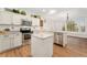 Bright kitchen with granite countertops, stainless appliances, and center island at 7860 E Ellsworth Ave, Denver, CO 80230