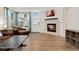 Cozy living room featuring a tiled fireplace and hardwood floors at 7860 E Ellsworth Ave, Denver, CO 80230