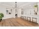 Open-concept living space with hardwood floors and view into the kitchen and entry at 7860 E Ellsworth Ave, Denver, CO 80230