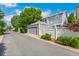Exterior street view of a well maintained home with a detached garage and manicured landscaping at 7860 E Ellsworth Ave, Denver, CO 80230