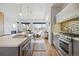 Modern kitchen with stainless steel appliances, countertops, backsplash, and hardwood floors at 2540 N Clay St, Denver, CO 80211