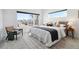 Bright main bedroom boasts expansive windows with city views and modern, neutral decor at 2540 N Clay St, Denver, CO 80211