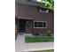Traditional brick home with a covered front entry and manicured lawn offers classic charm at 12640 W Virginia Ave, Lakewood, CO 80228