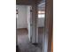 Hallway with bedroom entries featuring carpet and neutral paint at 12640 W Virginia Ave, Lakewood, CO 80228