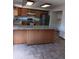 Open kitchen design with center island, stylish countertops, wood cabinets, and stainless appliances at 12640 W Virginia Ave, Lakewood, CO 80228