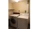 A laundry room featuring a washer and dryer with white walls and tile flooring at 12640 W Virginia Ave, Lakewood, CO 80228