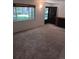 Carpeted living room featuring a large window and a fireplace at 12640 W Virginia Ave, Lakewood, CO 80228