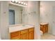 Shared bathroom with double vanity and light wood cabinets at 470 Grey Swallow St, Brighton, CO 80601
