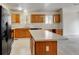 Bright kitchen with oak cabinets, island, and black appliances at 470 Grey Swallow St, Brighton, CO 80601