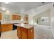 Open concept kitchen features an island and access to backyard at 470 Grey Swallow St, Brighton, CO 80601