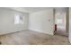 Open living space with carpeted floors and views into the kitchen at 470 Grey Swallow St, Brighton, CO 80601