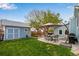 A backyard with a shed, patio with furniture, and green lawn at 11551 W 103Rd Dr, Broomfield, CO 80021