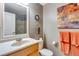 Neutral bathroom with a granite countertop vanity, framed mirror, and adjacent shower with tiled backsplash at 11551 W 103Rd Dr, Broomfield, CO 80021
