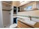 Bright bathroom featuring white tiled shower, built-in shelves, and a vanity with a granite countertop at 11551 W 103Rd Dr, Broomfield, CO 80021