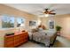 Sunlit bedroom with comfortable bed and matching dresser set at 11551 W 103Rd Dr, Broomfield, CO 80021