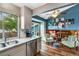 Bright kitchen flows into a living space with wood floors and cozy seating at 11551 W 103Rd Dr, Broomfield, CO 80021