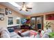 Bright living room with vaulted ceiling and glass doors to backyard at 11551 W 103Rd Dr, Broomfield, CO 80021
